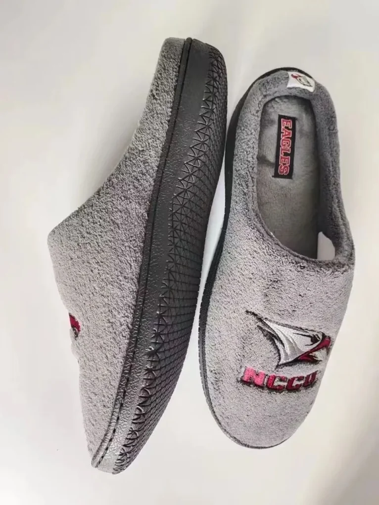 IMG_1535 Gray indoor slippers featuring a red and white eagle logo and embroidered "NCCU" on the side, with textured black soles.