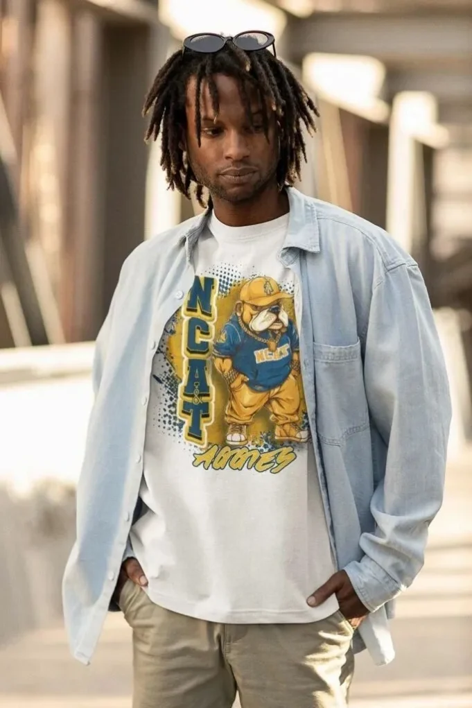 Person wearing a light blue denim shirt over a graphic T-shirt featuring a cartoon bulldog, in a stylish, urban setting Person wearing a light blue denim shirt over a graphic T-shirt featuring a cartoon bulldog, in a stylish, urban setting